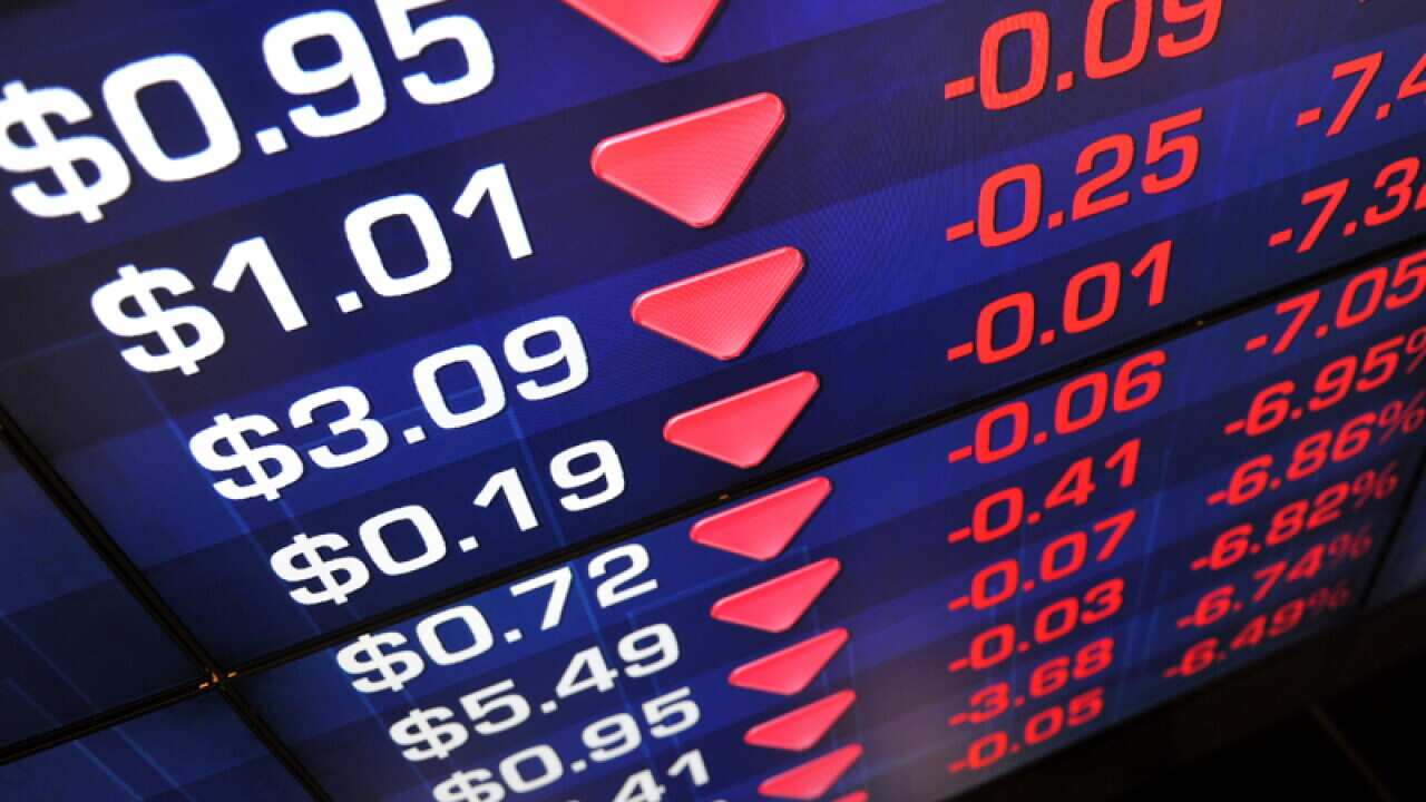 A screen displays stock market prices in Sydney