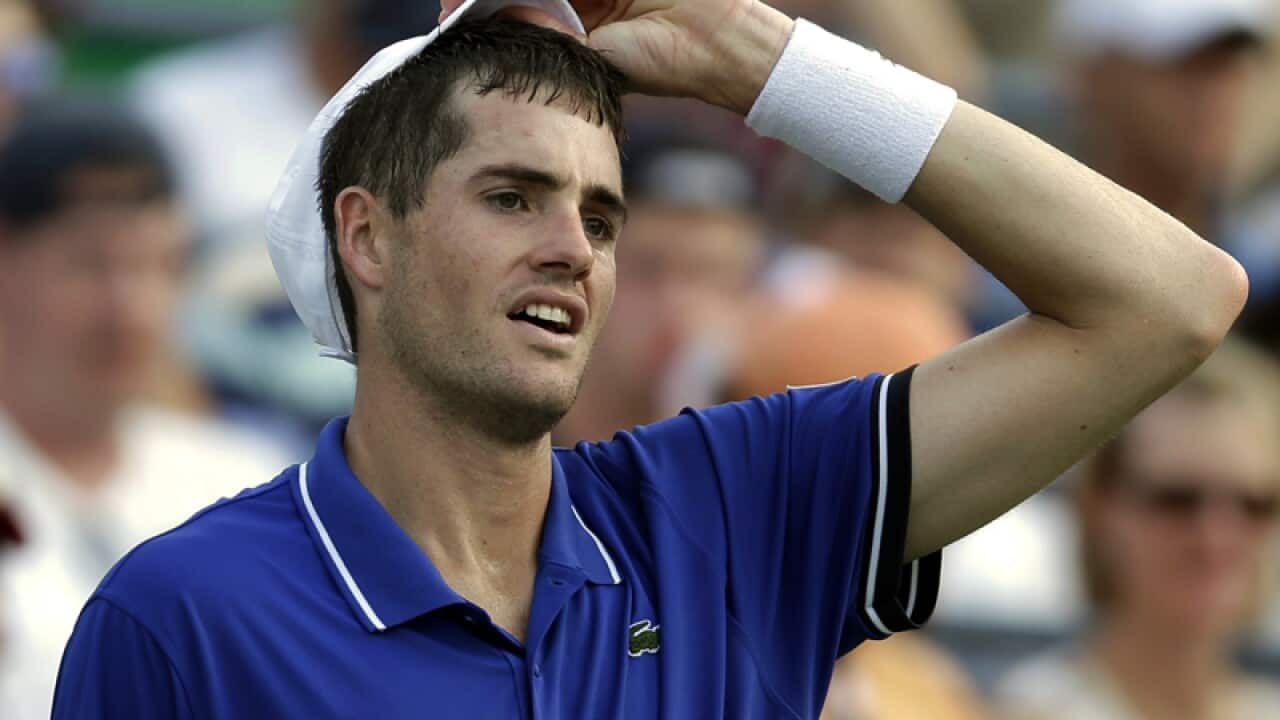 John Isner reacts after losing a point to Philipp Kohlschreiber