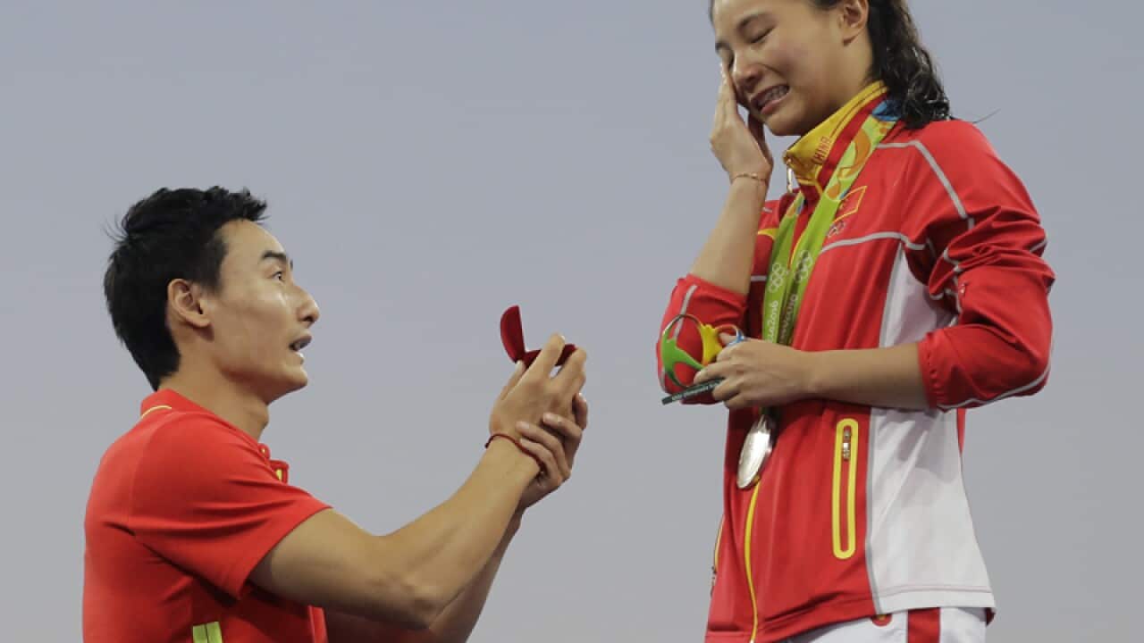 Chinese diver He Zi (R) accepts a marriage proposal from Qin Kai