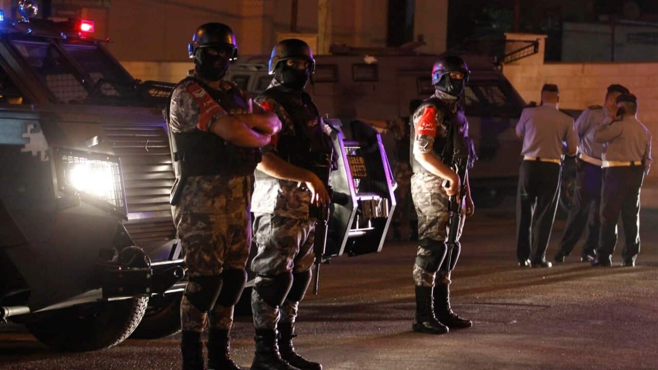 Jordanian security forces stand infront of their armored vehicle next to the Israel embassy, in Amman, Jordan, 23 July 2017.