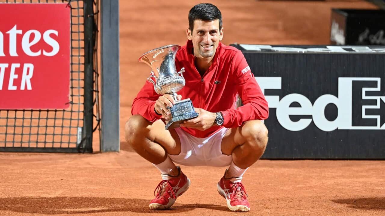 Serbia's Novak Djokovic poses with his trophy after winning his match with Argentina's Diego Sebastián Schwartzman during their final match at the Italian Open tennis tournament, in Rome, Monday, Sept. 21, 2020.