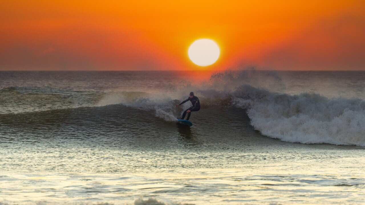 surfing beach sunset
