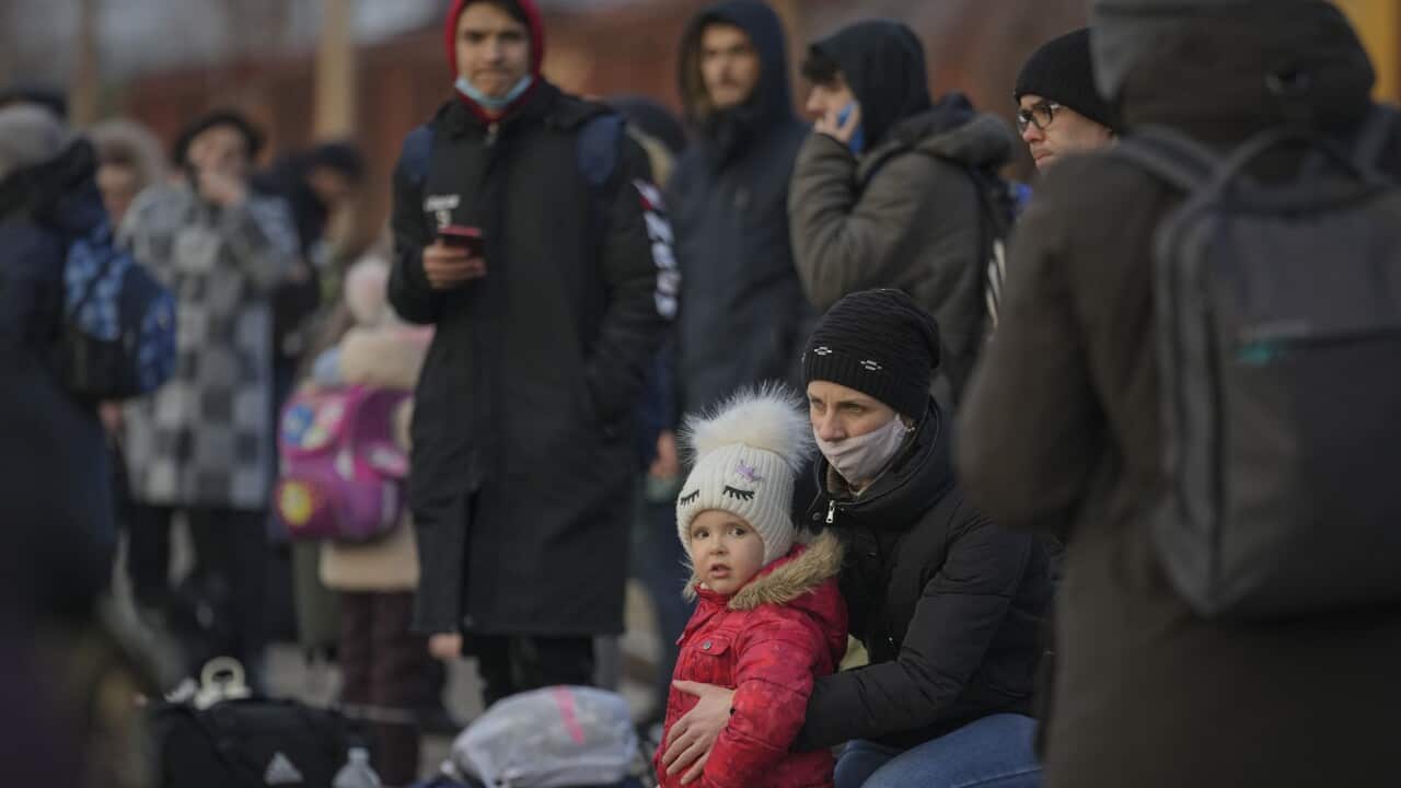 People waiting for a Kyiv bound train gather on the platform in Kramatorsk, the Donetsk region, eastern Ukraine, Thursday, Feb. 24, 2022