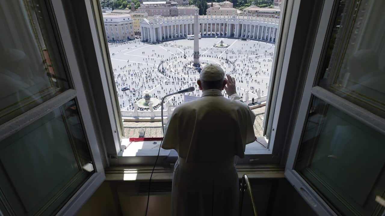 Pope Francis delivers his blessing overlooking St. Peter's Square at the Vatican