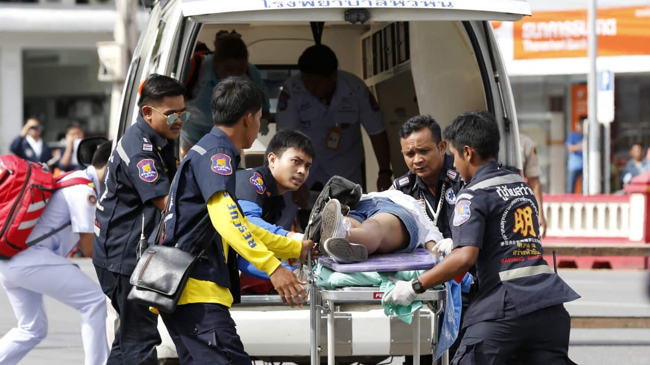 Thai rescue workers rush an injured victim to a hospital after two bombs exploded at the city clock tower in the center of Hua Hin, Thailand, 12 August 2016.