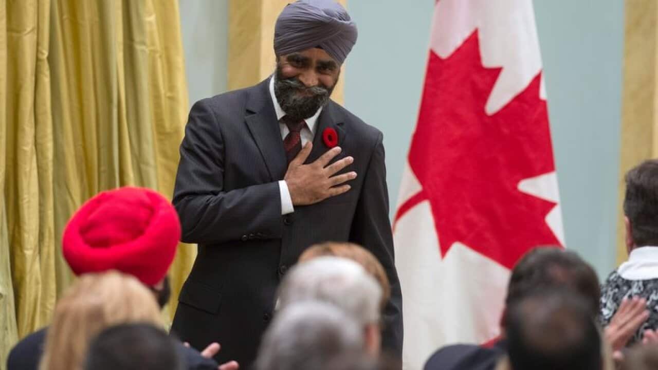 Defense Minister Harjit Singh Sajjan reacts after being sworn in during a ceremony at Rideau Hall, Wednesday Nov. 4, 2015 in Ottawa.