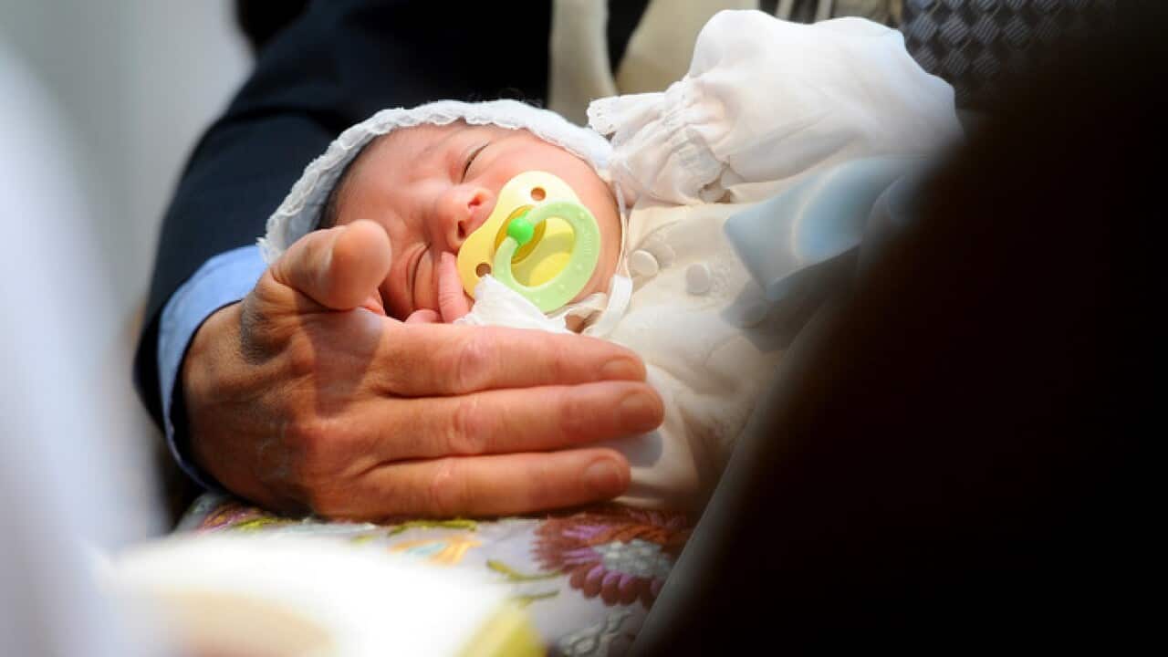 A male baby closes his eyes during his Bris, a Jewish circumcision ceremony