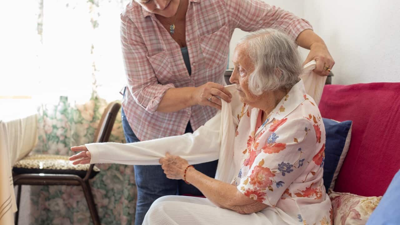 Mature woman caring for her elderly mother