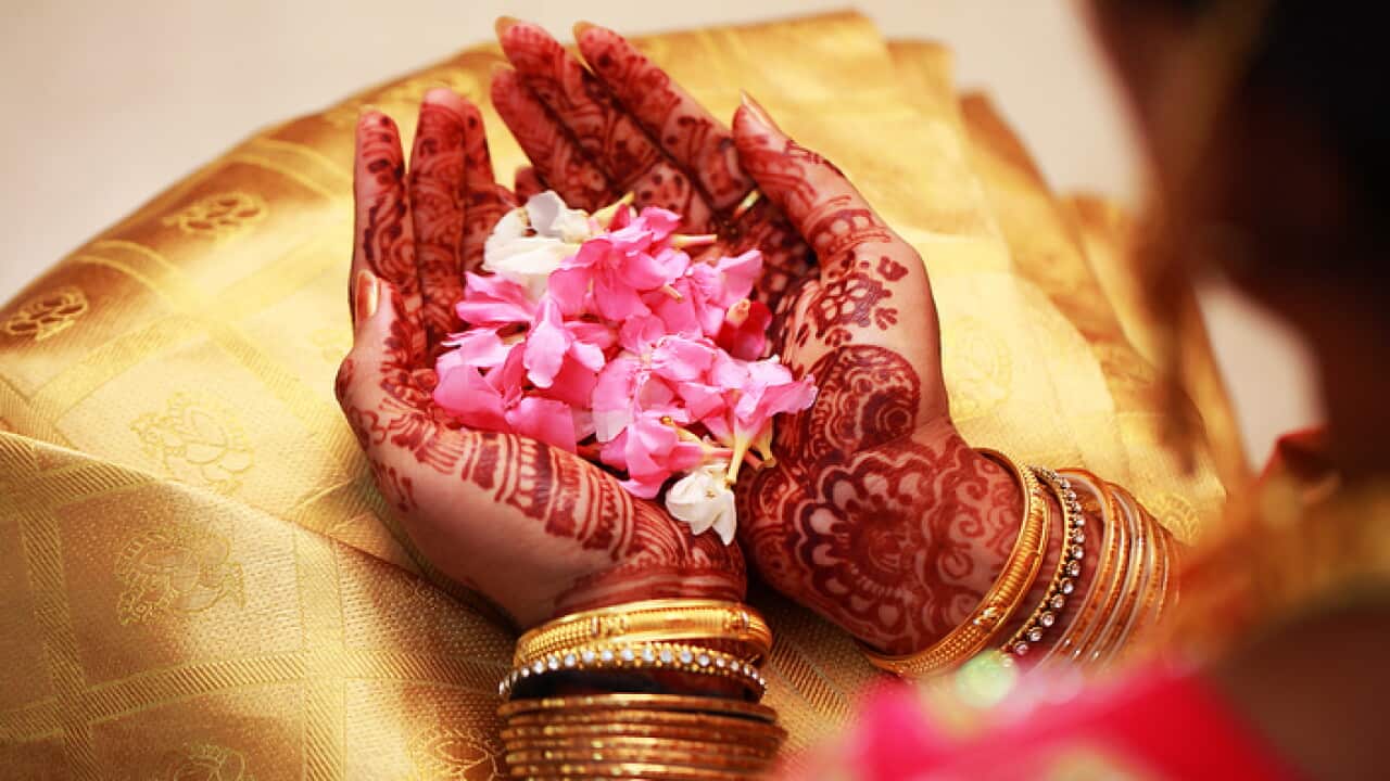 bride holding flower, Indian wedding ceremony