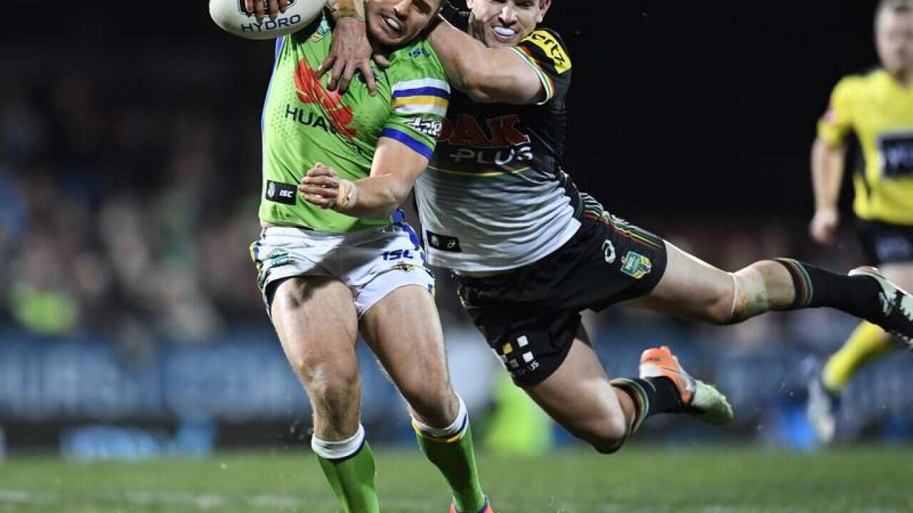 Tim Browne of the Panthers tackles Aidan Sezer of the Raiders