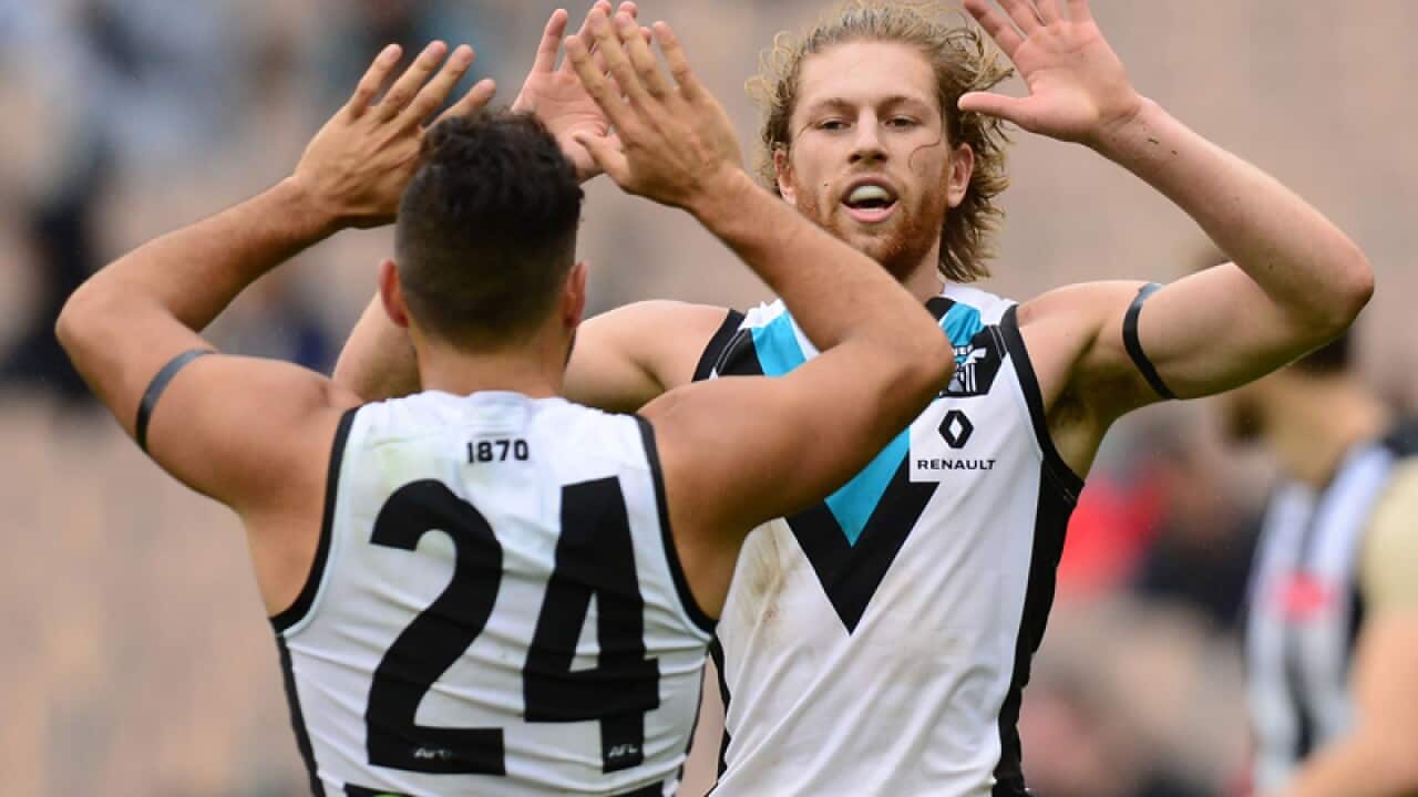 Aaron Young (C) of Port Adelaide