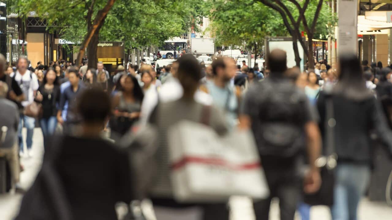 Crowd of people walking down Pitt St, Sydney.