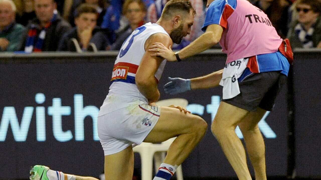 Western Bulldogs' Travis Cloke gets up after an injury