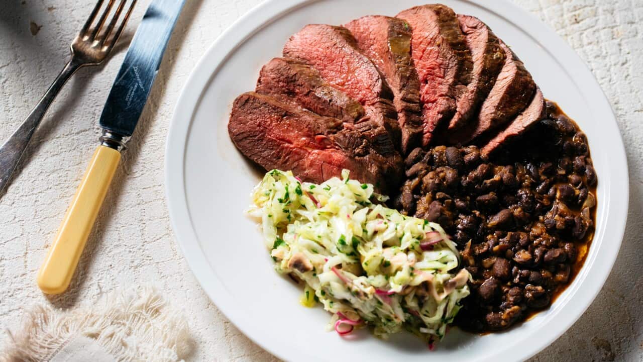 Grilled venison topside with cabbage salad and black beans