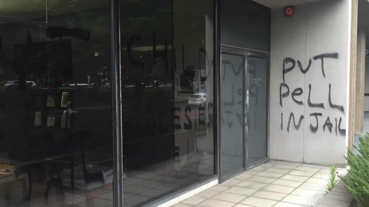 Images of graffiti on the Catholic Archdiocese building.