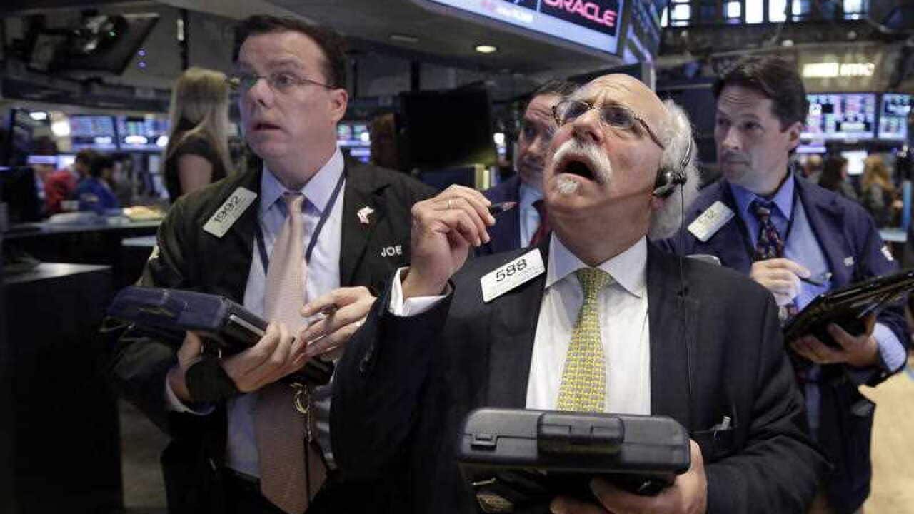 Peter Tuchman, foreground right, works with fellow traders on the floor of the New York Stock Exchange, Monday, Aug. 24, 2015. U.S. stock markets plunged in early trading Monday following a big drop in Chinese stocks. (AP Photo/Richard Drew)