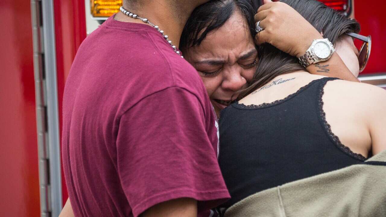 Friends and family grieve after a list of hospitalized victims was releasednear the Orlando Regional Medical Center in Orlando, Fla., Sunday, June 12, 2016.