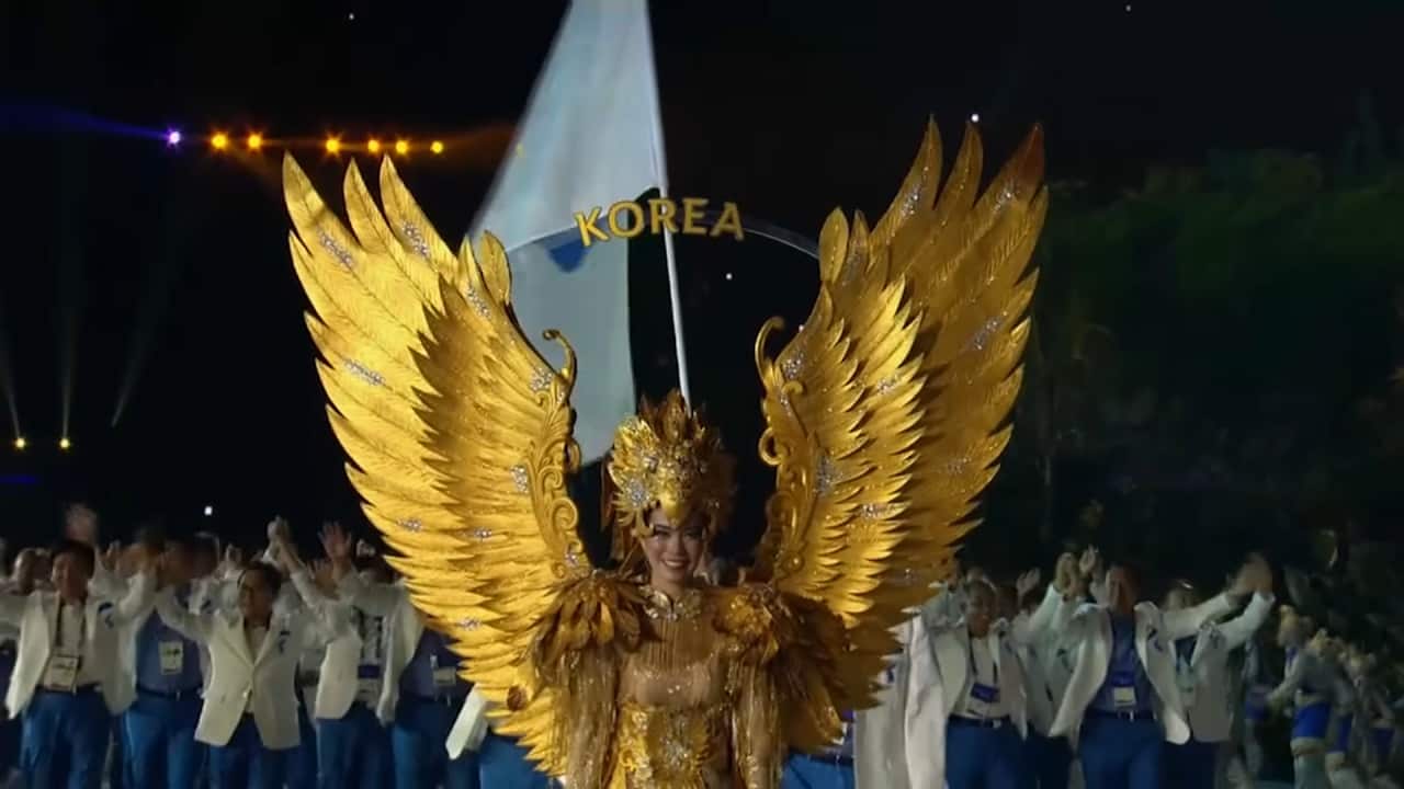 Thousands of spectators cheered as athletes from the rival Koreas paraded side-by-side behind a "unification" flag at the Asian games in Indonesia