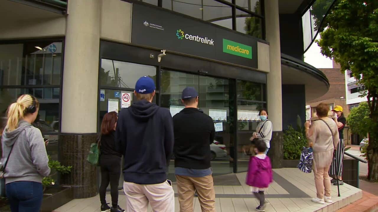 People waiting outside a CentreLink office