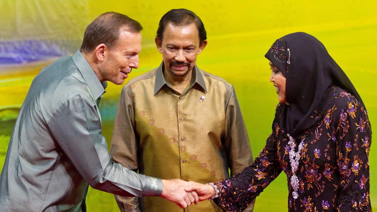 Brunei's Sultan Hassanal Bolkiah (C) and his wife Queen Saleha (R) greet Tony Abbott - AAP.jpg