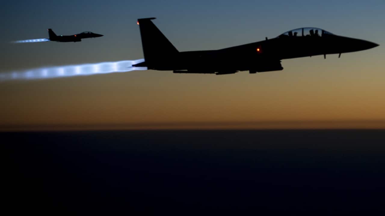 a pair of U.S. F-15E Strike Eagle fly over northern Iraq,