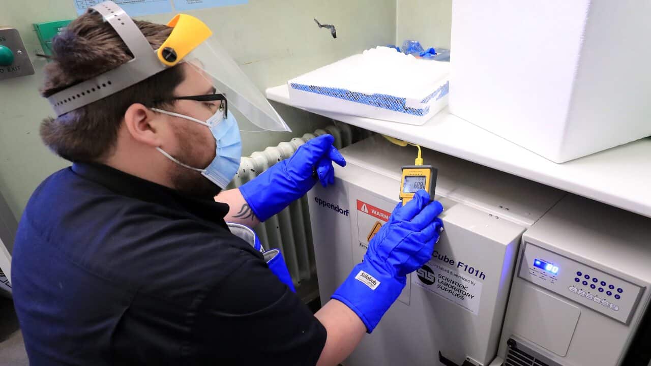 A pharmacy technician takes delivery of the first batch of COVID-19 vaccinations at Croydon University Hospital in south London on 5 December, 2020.