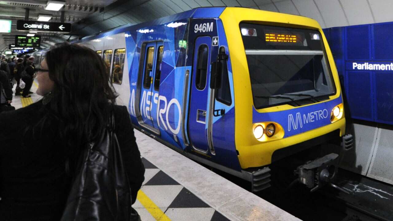 A Metro train approaches Parliament station