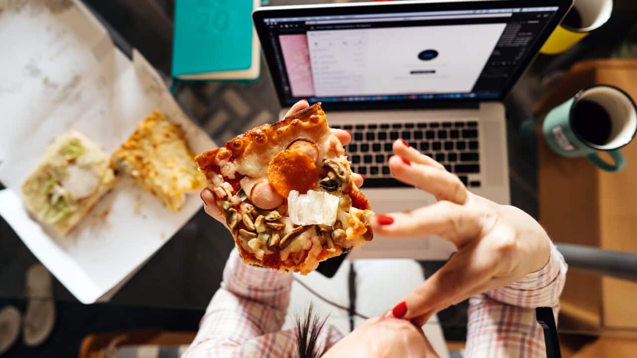 Eating pizza in front of computer