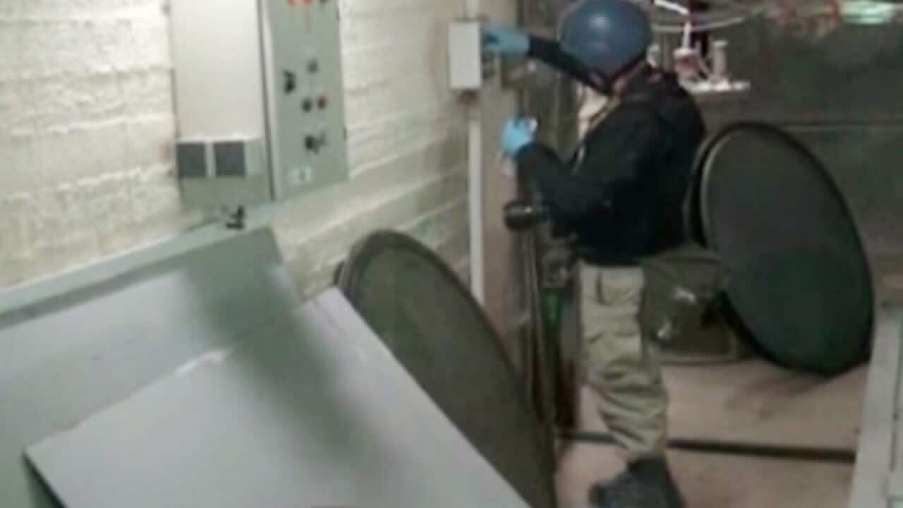 An inspector from the OPCW working at a site