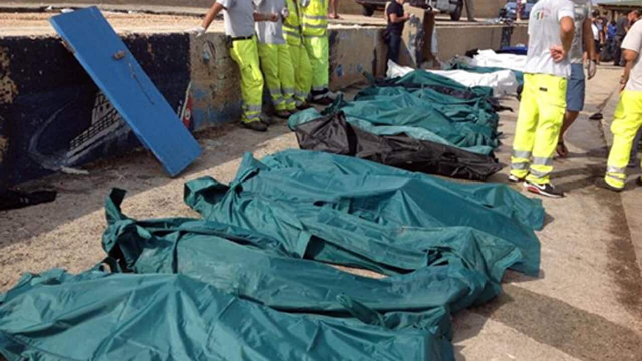 A row of bodies are covered with sheets in Lampedusa - AAP.jpg