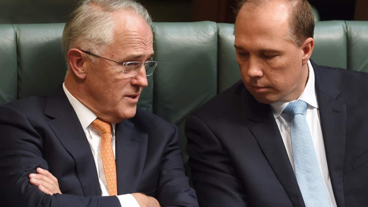PM Malcolm Turnbull (L) speaks to Peter Dutton