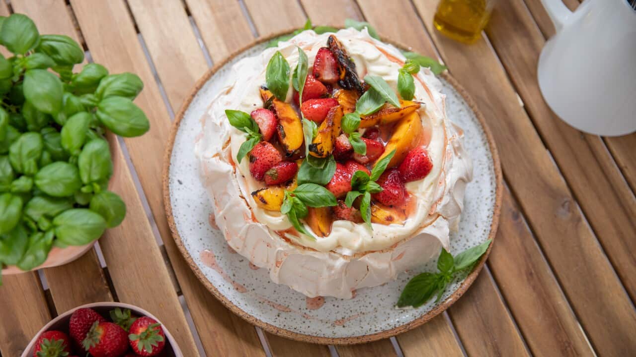 Barbecued pavlova, covered in grilled summer fruits and basil and sumac syrup