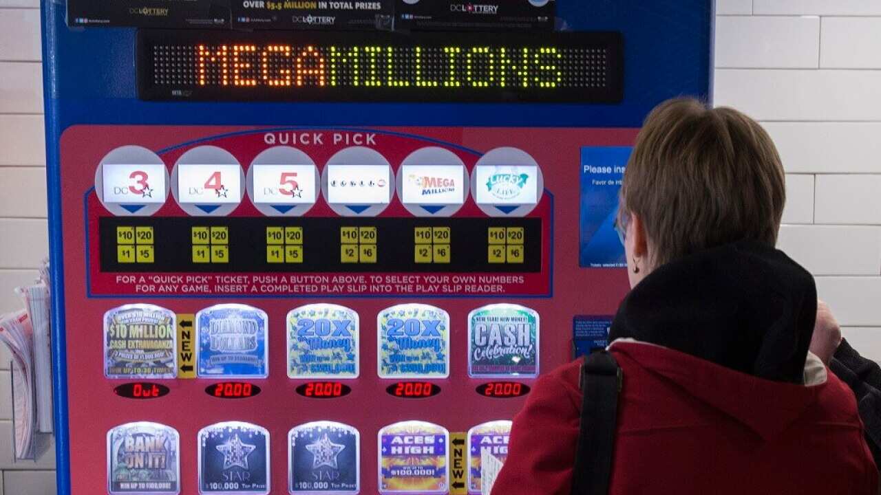 A woman buys lottery tickets from a machine in Washington as Mega Millions has a record jackpot on offer.