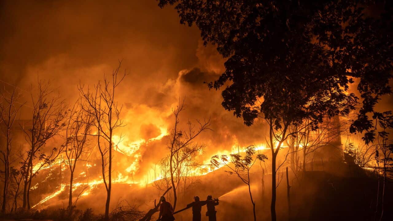 Firefighters try to contain a fire at a warehouse facility during a wild fire near Oraiokastro, on the northwest outskirts of Thessaloniki (Konstantinos Tsakalidis-Bloomberg via Getty Images).