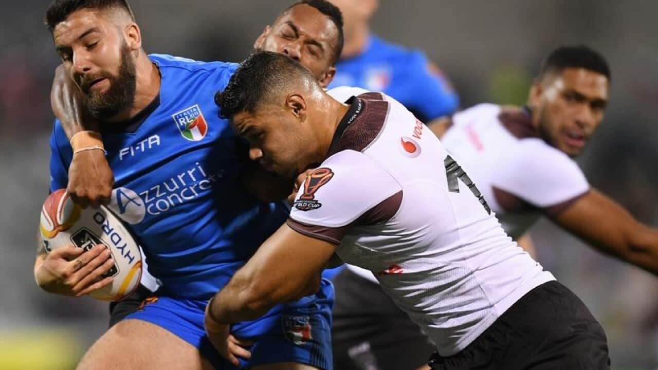 Mason Cerruto of Italy is tackled by Brayden Wiliame of Fiji