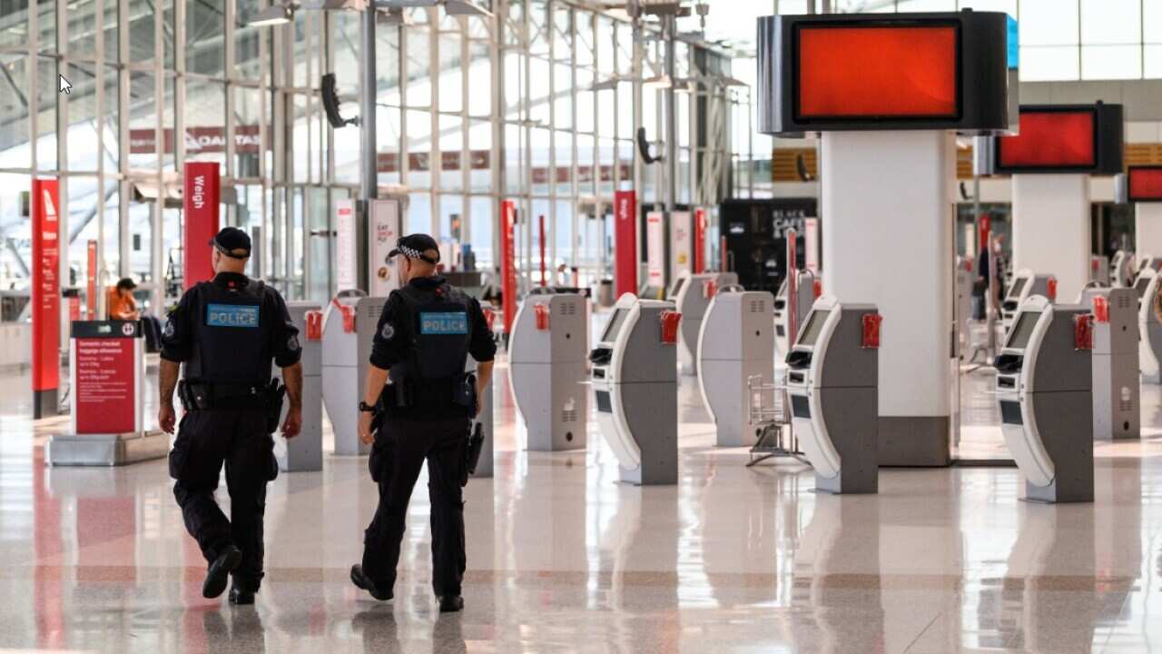 Police Officers patrolling in the Departures Hall of Sydney Domestic Airport.