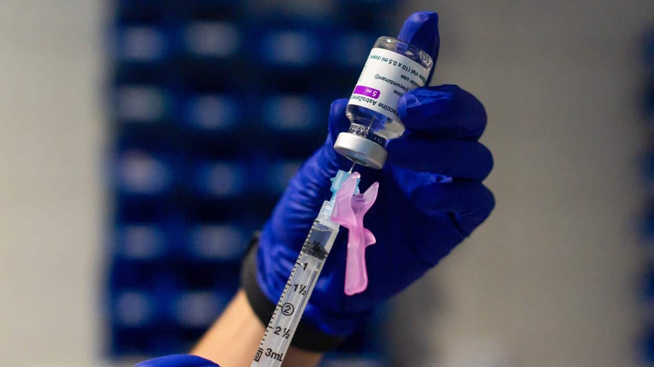 A healthcare worker prepares syringe with vaccine
