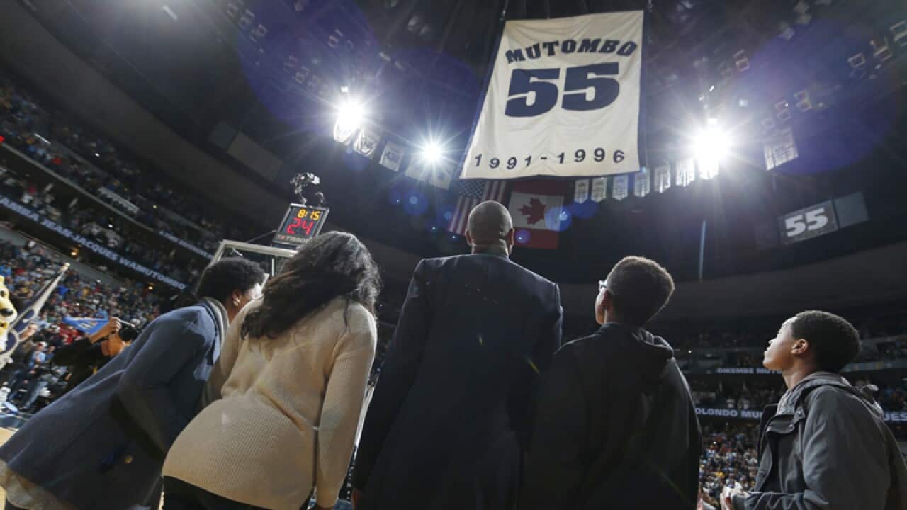 Retired Denver Nuggets center Dikembe Mutombo (c)