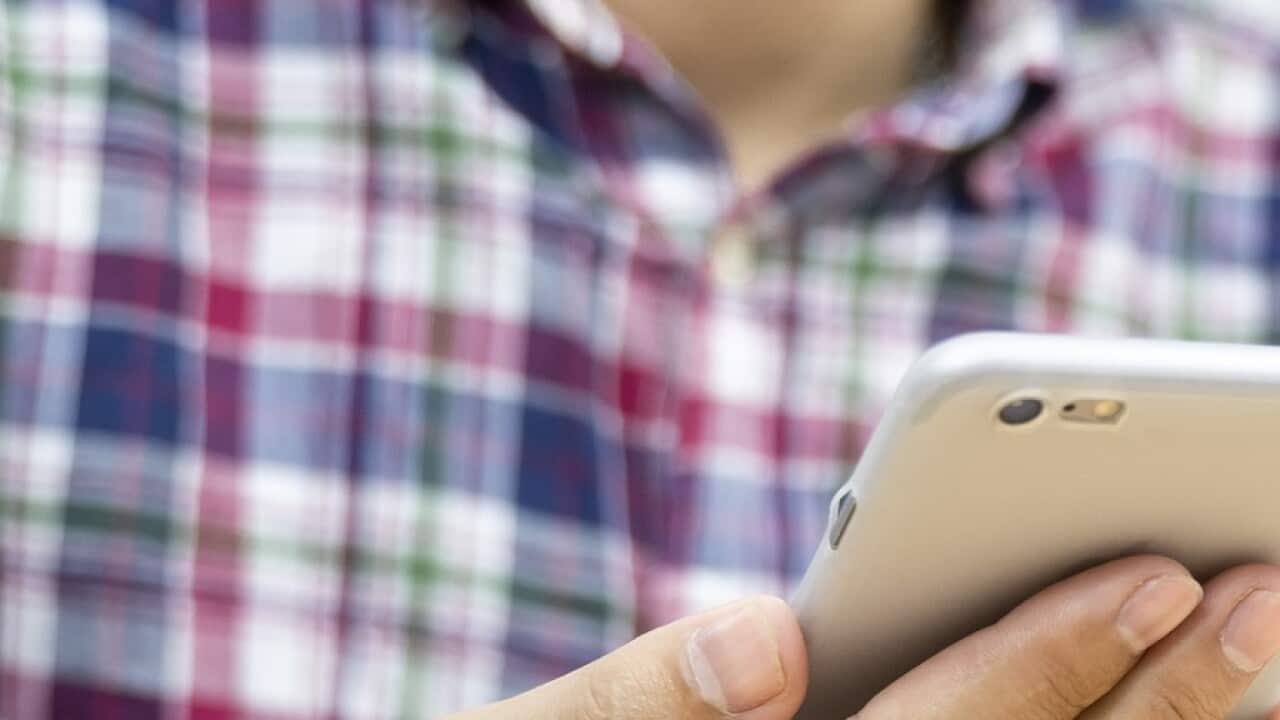 Young man hands holding credit card and using phone