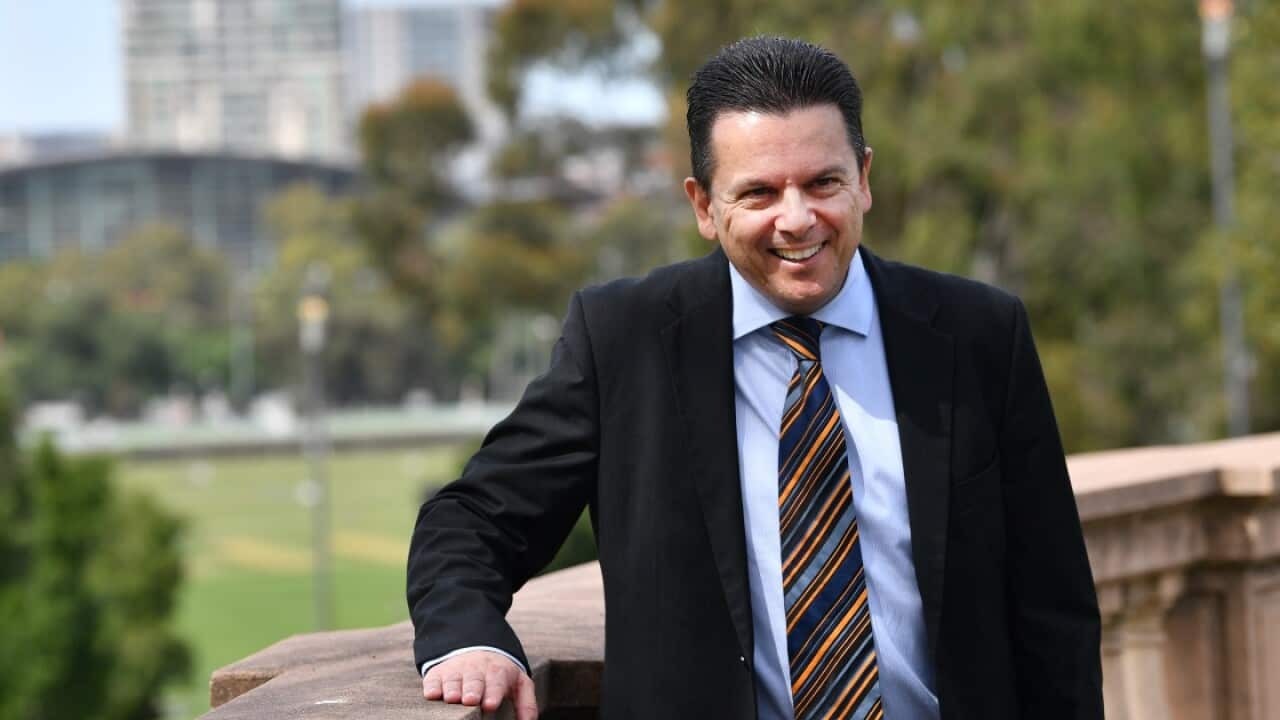 Senator Nick Xenophon poses for a photo after his announcement to the media in Adelaide that he is quitting the Senate