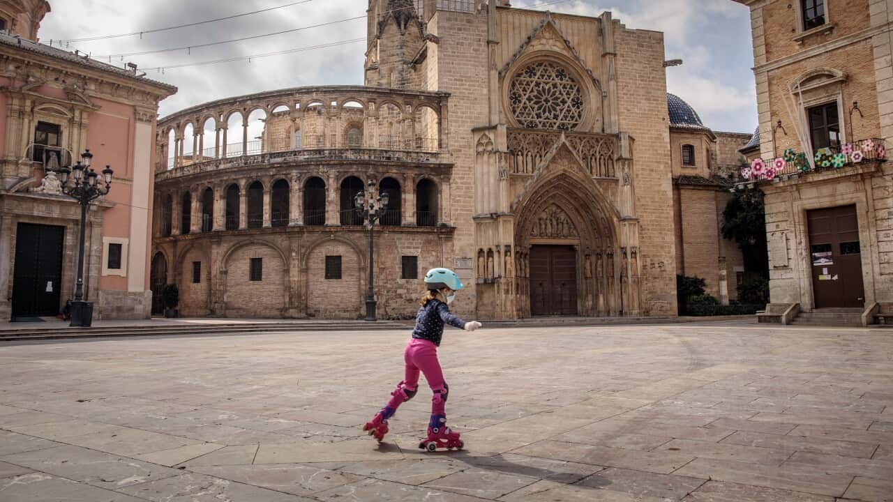 A child skates on a deserted square in Valencia, Spain