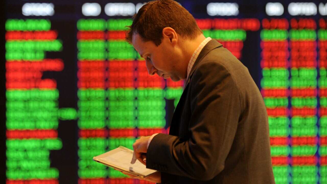 A man watched stocks at the Australian Stock Exchange.