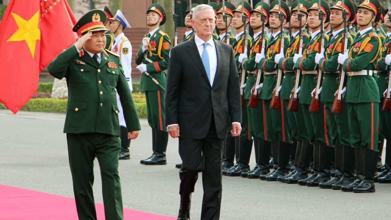 Jim Mattis (R) attends a welcome ceremony with Vietnamese Defense Minister Ngo Xuan Lich in Hanoi.