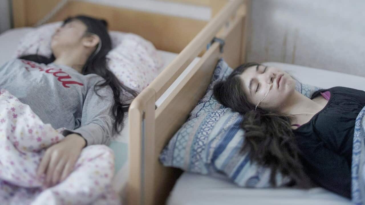 Two motionless sisters as they battle resignation syndrome in Sweden.