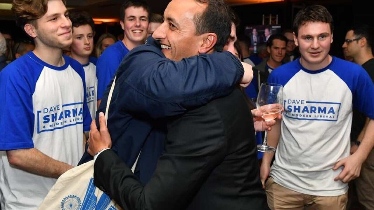 Liberal candidate for Wentworth Dave Sharma is hugged by supporters.