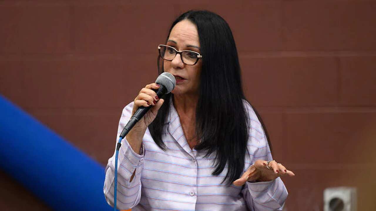 A woman speaking into a microphone.
