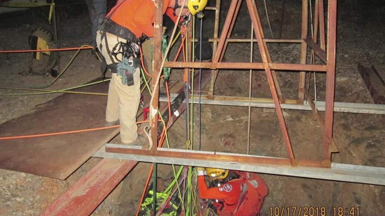 A rescue crew is lowered into the abandoned mine shift
