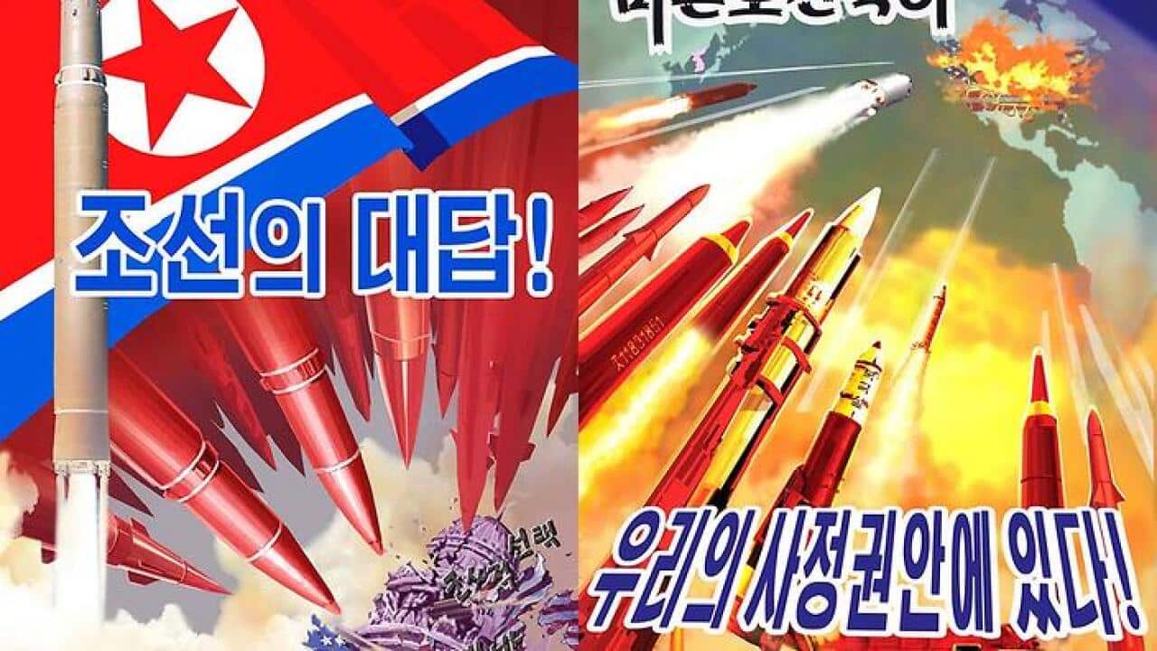 A man walks past a propaganda poster at a silk factory in Pyongyang on May 9, 2016. / AFP / Ed Jones (Photo credit should read ED JONES/AFP/Getty Images)