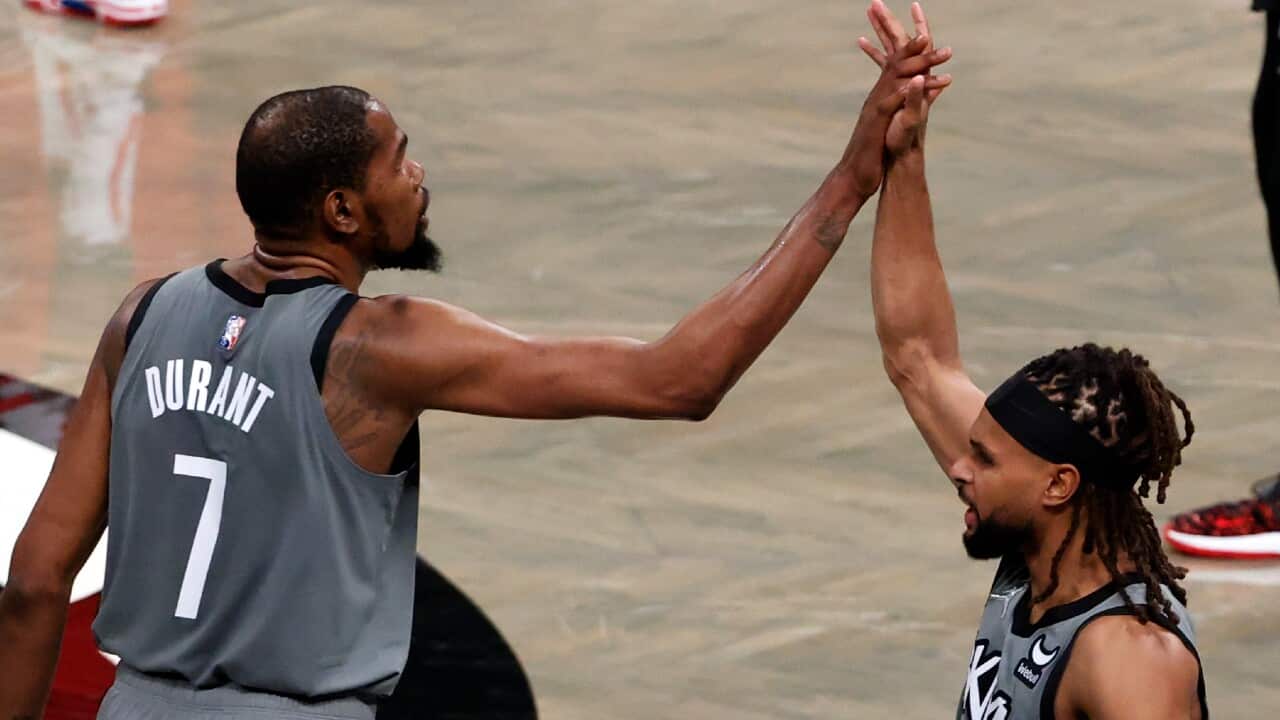 Kevin Durant and Patty Mills interact during a Brooklyn Nets game