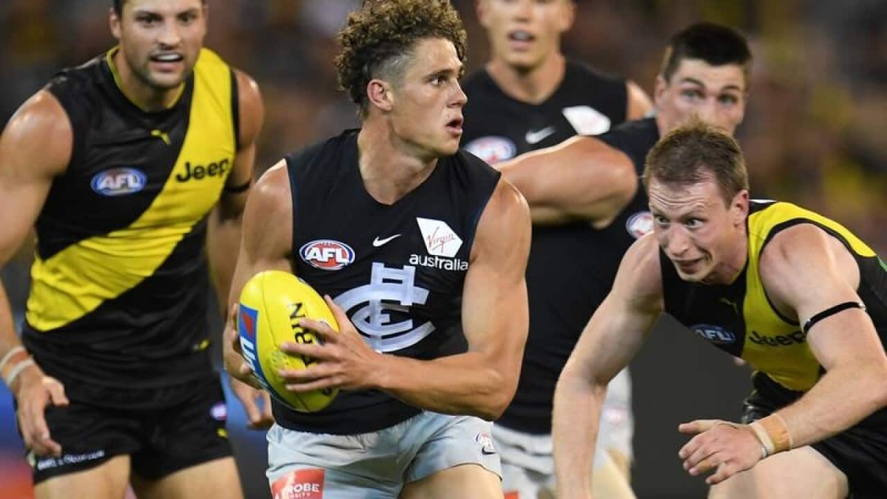 AFL player Charlie Curnow of the Blues with possession of the ball.